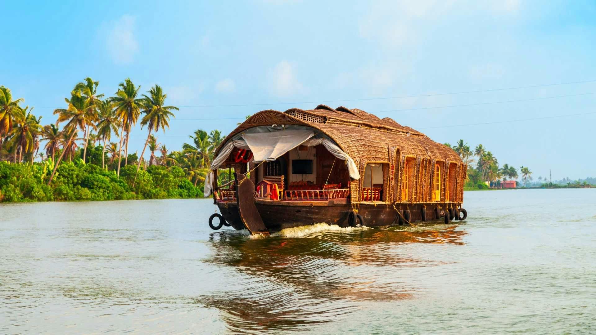 Image of house boat cruising through the backwaters of Alapuzha, Kerala