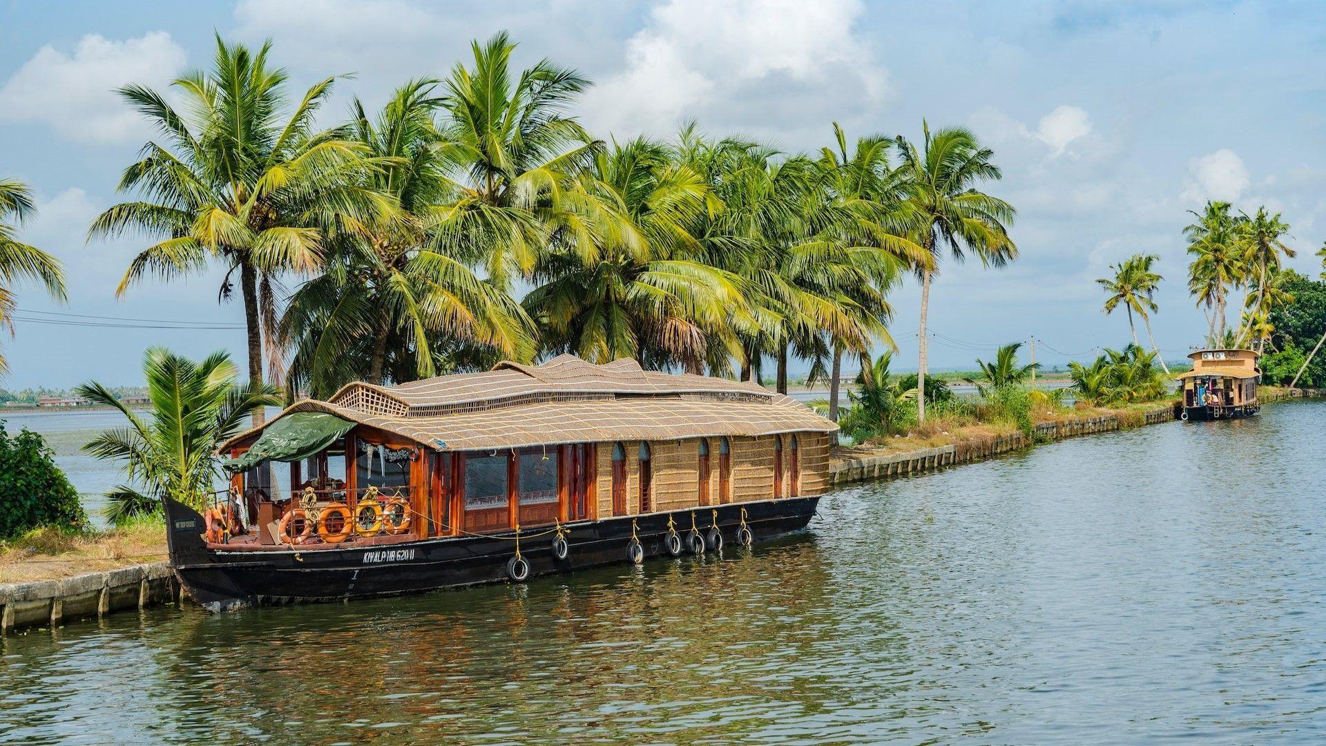 Image of House boat cruising through backwater in Kuttanad, kerala, India