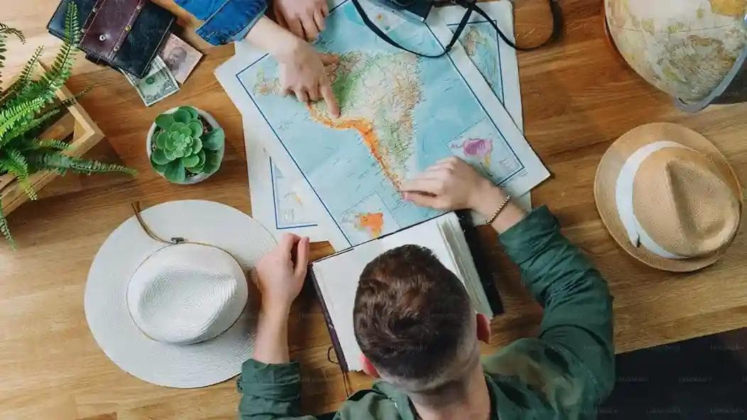 Image of two people sitting around table planning a trip 